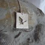 Silver Bat Pendant: A A Flying Bat Silhouetted On..