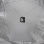 Silver Bat Pendant: A A Flying Bat Silhouetted On..