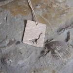 Silver Dinosaur Pendant: A Textured Sterling..