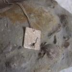 Silver Dinosaur Pendant: A Textured Sterling..