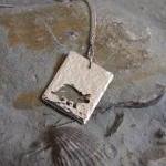Silver Triceratops Pendant: A Textured Sterling..
