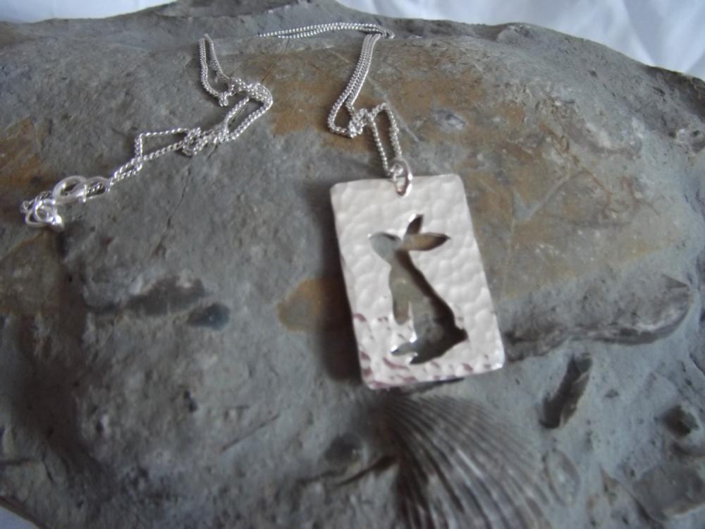 Silver Rabbit Pendant: A Curious Bunny Stands Up To Look Around At The World On A Background Of Textured Sterling Silver.